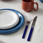Barro-Cup-set-of-2-natural_Barro-Plate-24-set-of-2-dark-blue_Barro-Plate-18-set-of-2-off-white_MVS-Cutlery-set-of-4-dark-blue.jpg