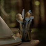 FermLiving_Holiday2025_SteloCutlery_SetOf4_BrushedStainlessSteel_1104272000_BoyaTallGlasses_SetOf2_SmokedGrey_1104272031 (1).jpg