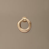 FermLiving_SS26_PackshotsWithBackground_OrrithDoorKnocker_Brass_1104273180.jpg