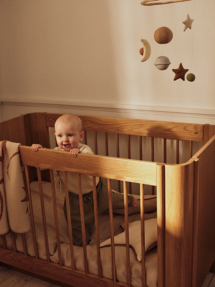 FermLiving_SS26_SkyeMobile_1104273156_TiluBabyCot_1104273074_SkyeBlanket_1104273046_StarCushion_1104273196.jpg