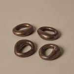 FermLiving_SS26_PackshotsWithBackground_OrrithNapkinRings_SetOf4_RusticBronze_1104272495.jpg