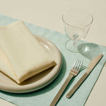 Curve-Stem-Glass-clear_Tavolo-Placemat-soft-mint_Tavolo-Napkin-soft-yellow.jpg
