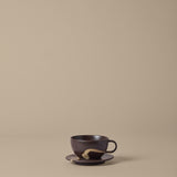 FermLiving_SS26_PackshotsWithBackground_KoyoCupWithSaucer_DarkBrown-Buff_1104272621.jpg