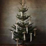 FermLiving_Holiday2025_BowDecoration_Small_SetOf2_Natural_1104272159_BowDecoration_Large_Natural_1104272160_DrapeBraidedTreeSkirt_Natural_1104271818 (3).jpg