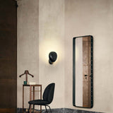 AdnetWallMirrorRectangular_BeetleDiningChairFullyUpholsteredConicBase_CobraWallLamp_On.jpg